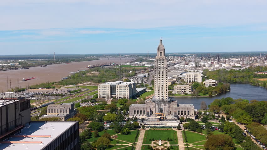 Aerial panorama of Baton Rouge city center with Louisiana State Capitol, historic architecture and Mississippi River waterfront.