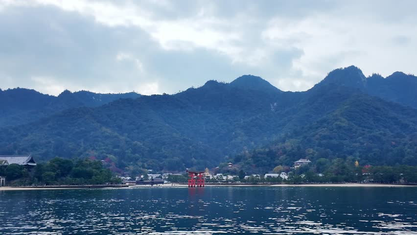 A view featuring a torii gate rising from the sea.