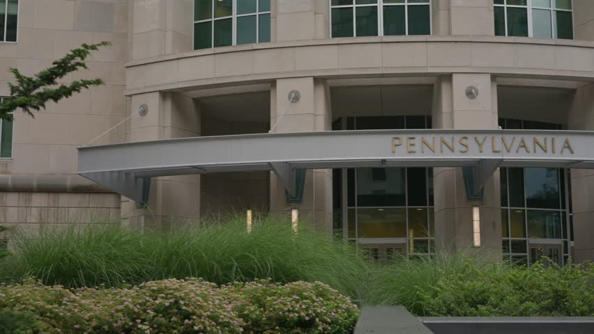 Cinematic pan right across the Pennsylvania Judicial Center in downtown Harrisburg Pennsylvania showcasing modern government architecture and the state judicial system headquarters.