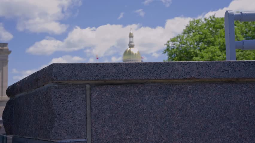 Cinematic dolly up shot from behind the New Jersey State House capitol building in downtown Trenton New Jersey showcasing historic government architecture.