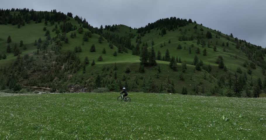 Riding mountain bike on the forest and grassland trail	