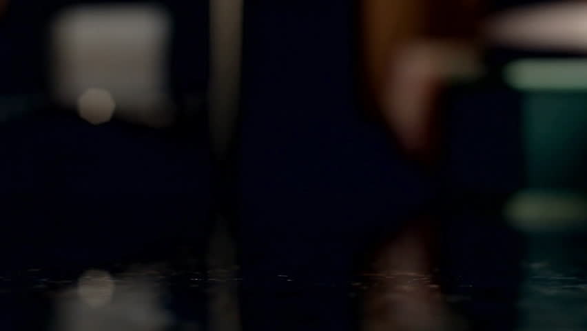 Woman Pouring Argentine Peso Coins From Glass Jar Onto Table And Picking One Up