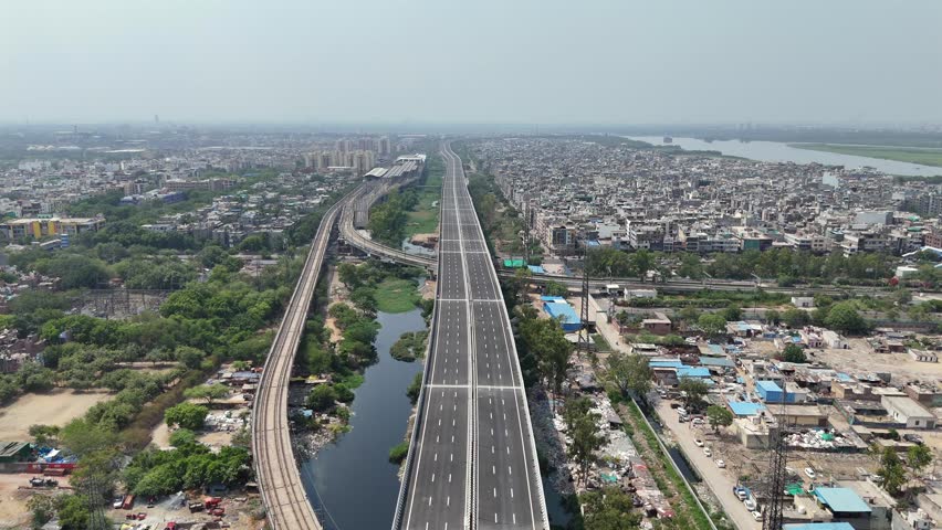 Aerial drone view of Delhi Metro crossing Yamuna Canal near Kalindi Kunj in New Delhi India