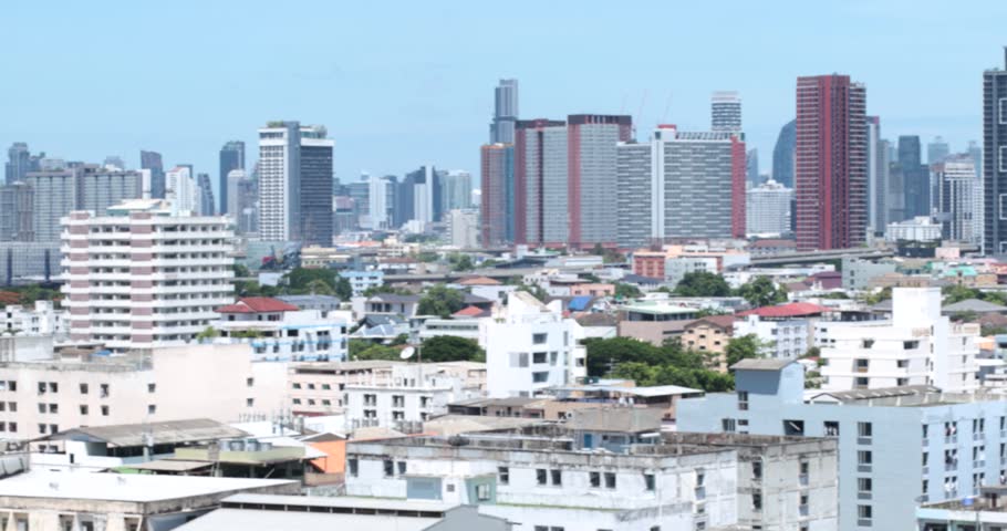 Blurred panoramic view of building Bangkok, Thailand skyline panorama from above, featuring modern cityscape, high-rise buildings, urban district, and daytime atmosphere