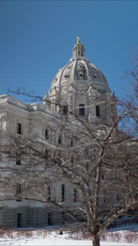 The video offers a close-up look at the State Capitol in St Paul, showcasing its design and the area around it on a bright day.