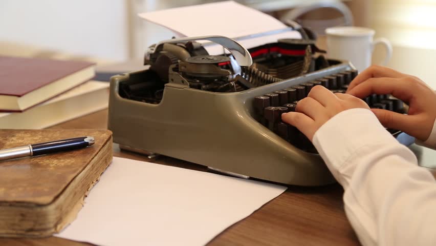 Writing a Book with a Typewriter. Author - Writer Concept.