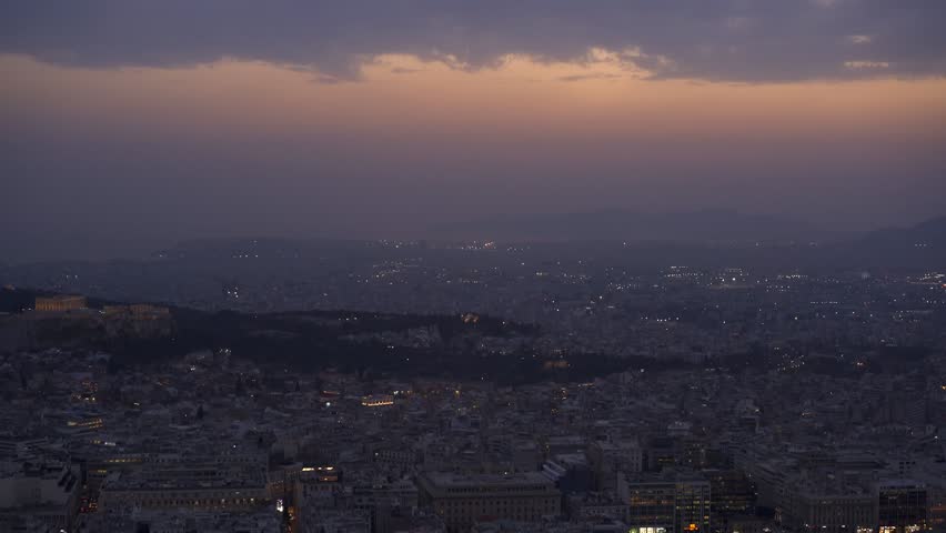 Athens city at sunset with Parthenon and Acropolis seen from Lycabettus hill viewpoint at sunset in Greece