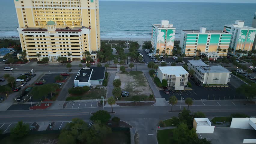 Aerial view of Myrtle Beach coastline with hotels, sandy beach, and ocean waves, showcasing the vibrant atmosphere of a coastal destination