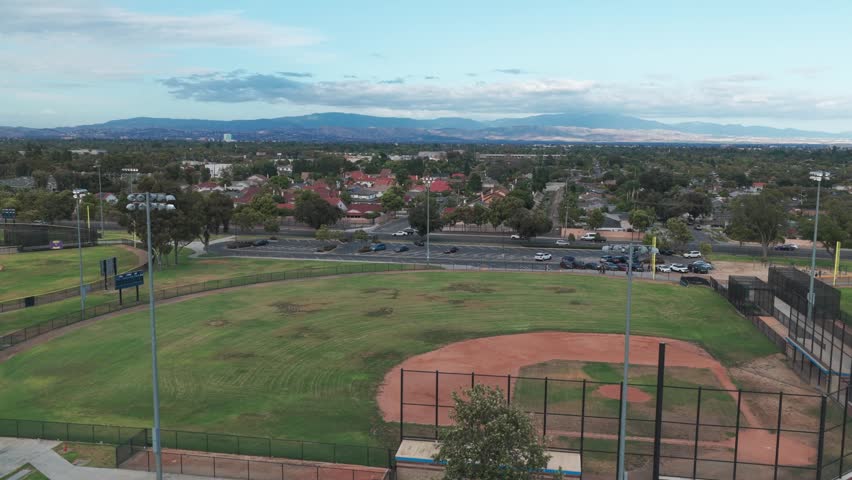 Wide panning aerial shot of a high school baseball field in Southern California. 4K