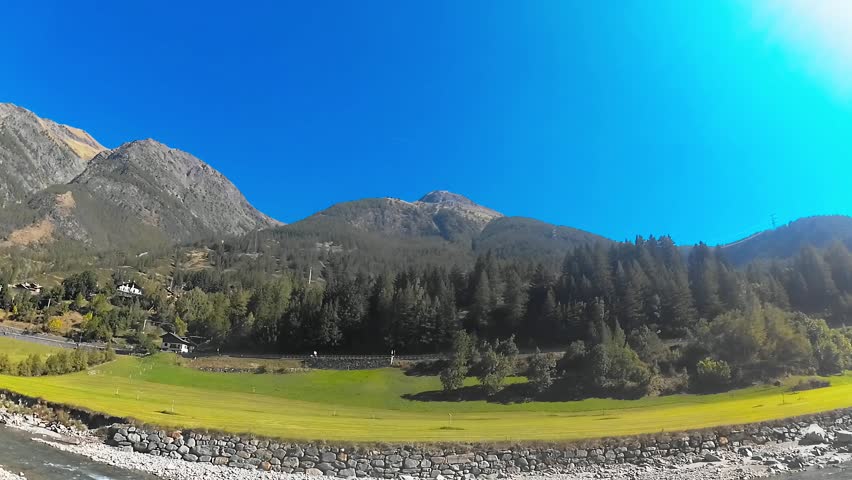 Alpine Landscape with Trees and River in Foreground