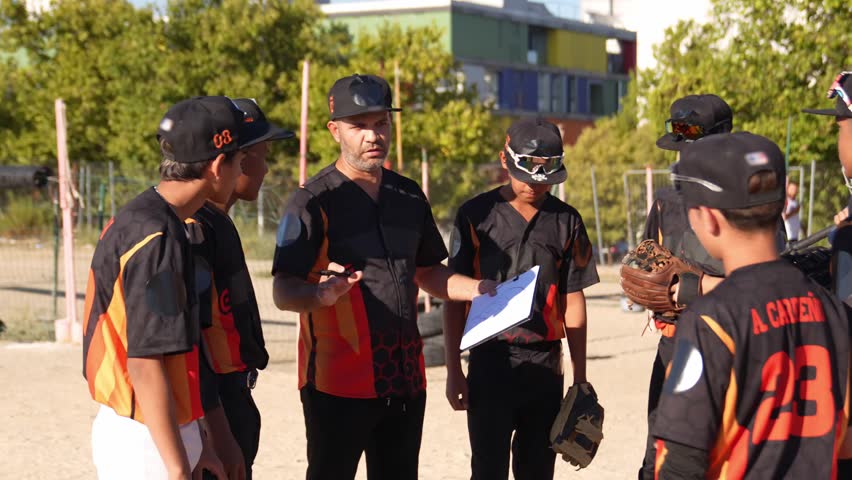 Focused youth baseball team listening to their coach