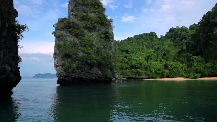 Scenic boat trip arriving at a beautiful hidden lagoon with a pristine sandy beach