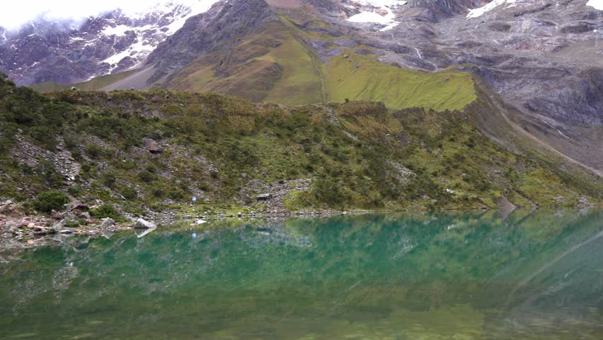 Blue Humantay Lake with snowy mountains in Peru
