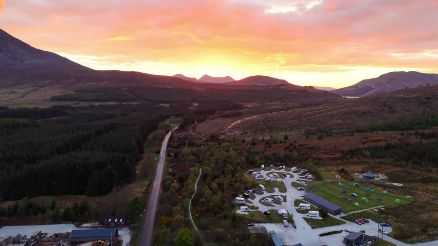 A beautiful drone shot of sunset overlooking a campsite on the Isle of Skye in Scotland on a normal sunny day