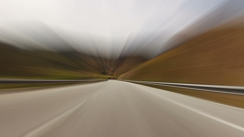 Empty road in the highlands. Very fast driving. Motion blur