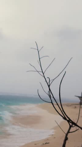 Beautiful scenic view of turquoise sea waves crashing on the shore with ambient wind and ocean sound, Lakshadweep Island, India.
