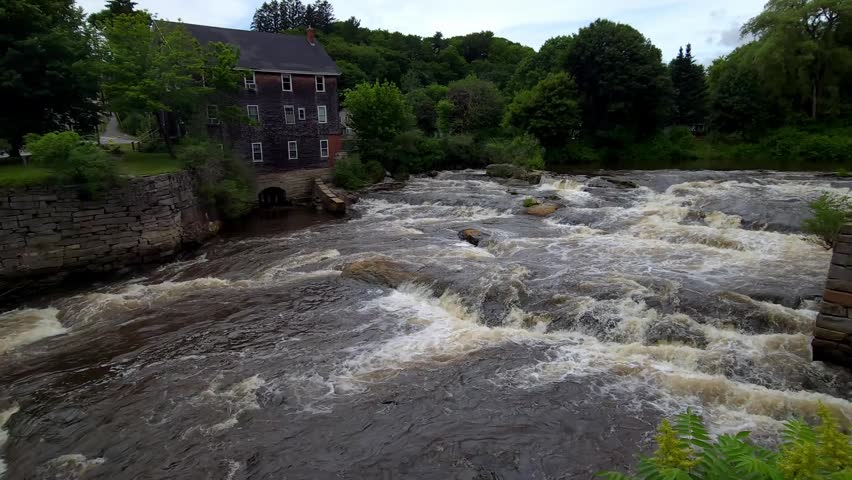 Raging white water runs trough rocks on Royal River Yarmouth, Maine