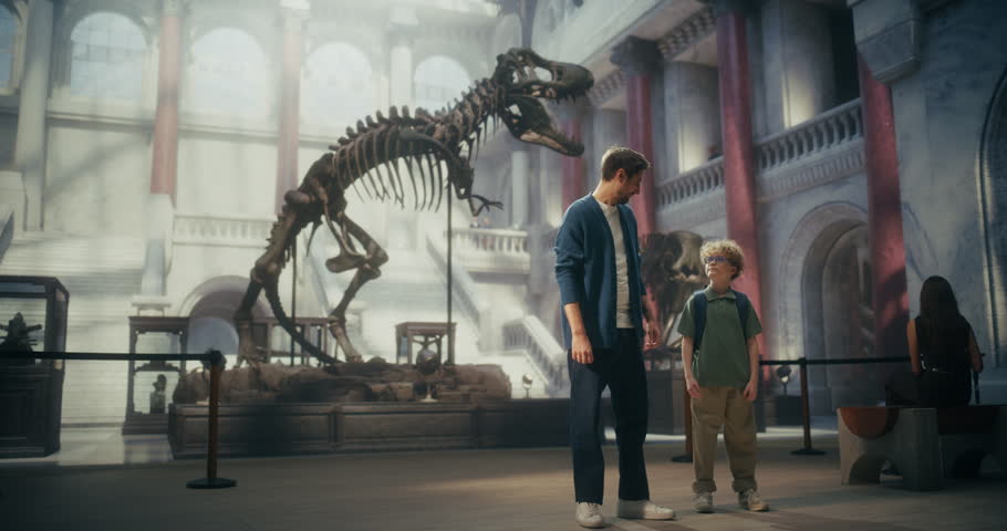 Natural History Museum Visit With Father and Young Son Watching a Giant T-rex Dinosaur Skeleton Exhibit. Family Spending Time together, Learning About Paleontology, Exploring Prehistoric Fossils