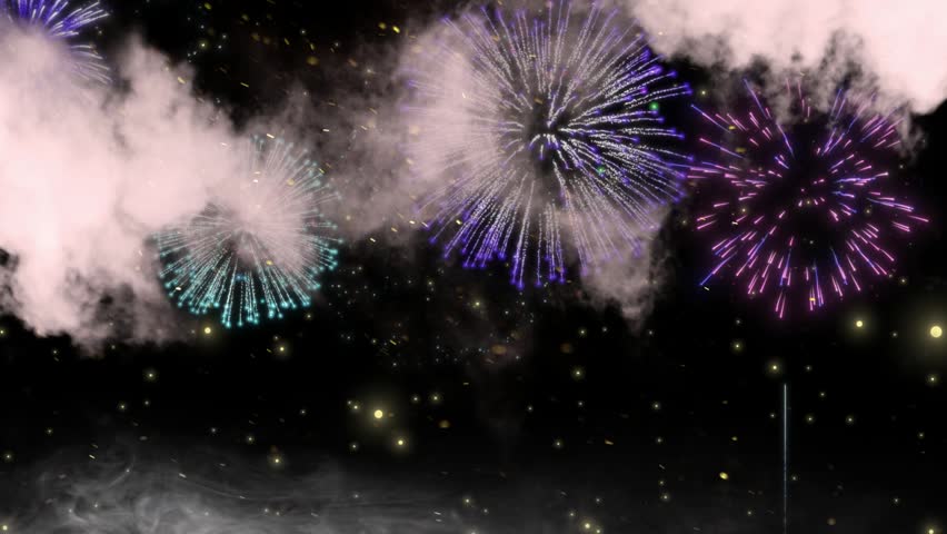 Vibrant multi-colored fireworks burst across a dark night sky with thick smoke.