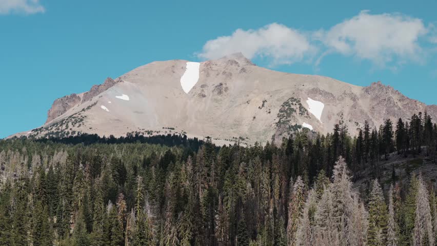 Clouds drift and birds fly over Mount Lassen at Lassen Volcanic National Park, California