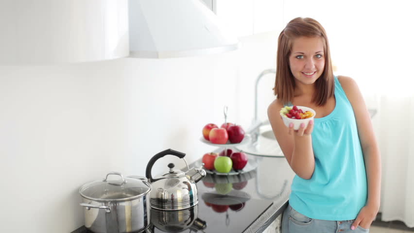 Girl eating fruits and smiling
