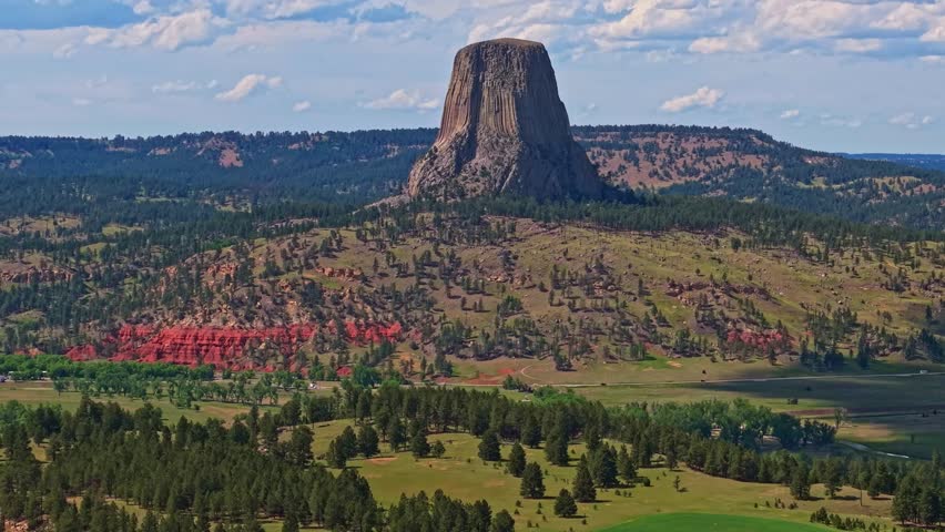 Close up aerial view of Devils Tower National Monument under clear skies in Wyoming