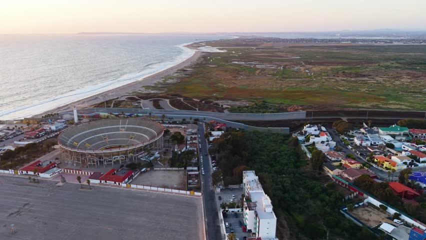 A striking high-angle aerial view of the vast architectural density and residential hillsides of Tijuana, Mexico.