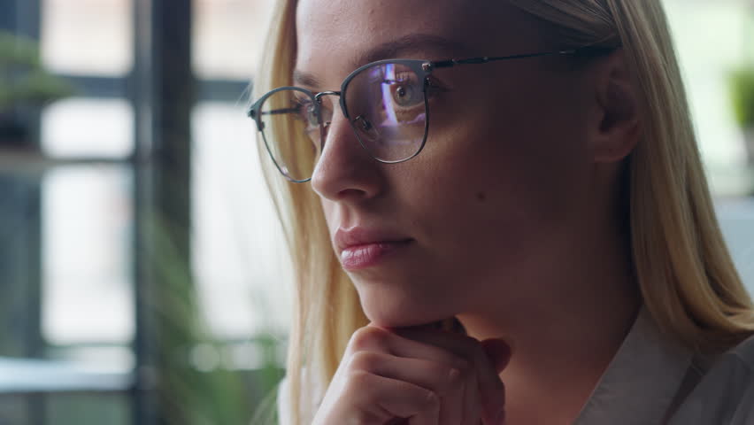 Portrait Caucasian business woman in glasses serious thinking looking at camera businesswoman student girl pensive in eyeglasses female face look in office working corporate job work manager employer