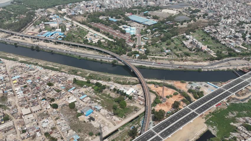 Aerial drone view of Delhi Metro crossing Yamuna Canal near Kalindi Kunj in New Delhi India
