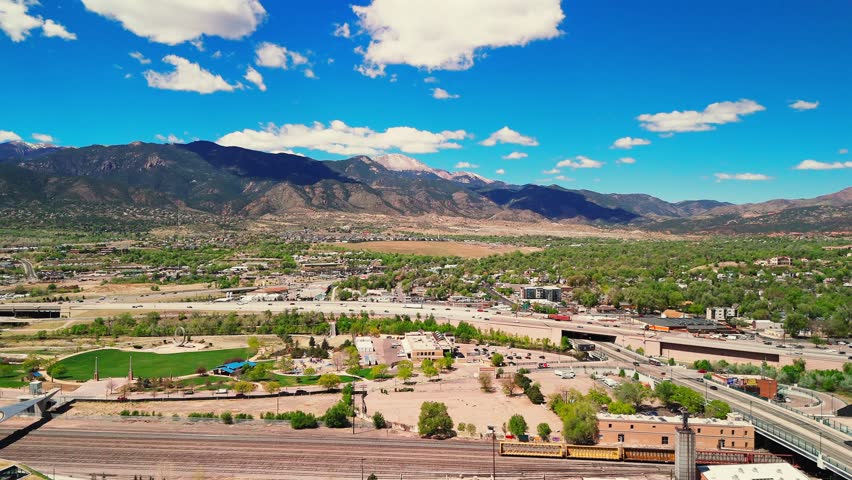 Forward Drone Flight Over Colorado Springs Neighborhoods with Mountain Backdrop