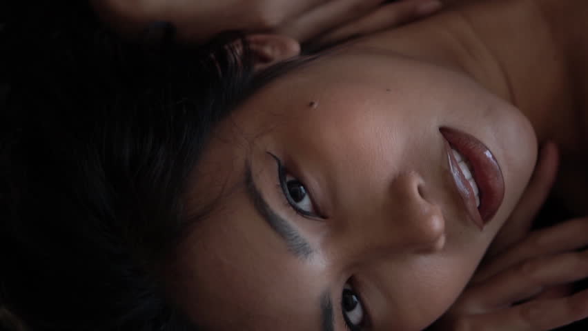 Portrait of Beautiful Asian Woman Lying on Bed
