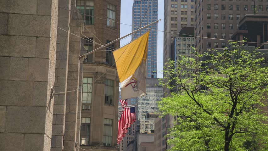 A close-up shot of The Vatican flag waving outside St. Patrick’s Cathedral in New York City.