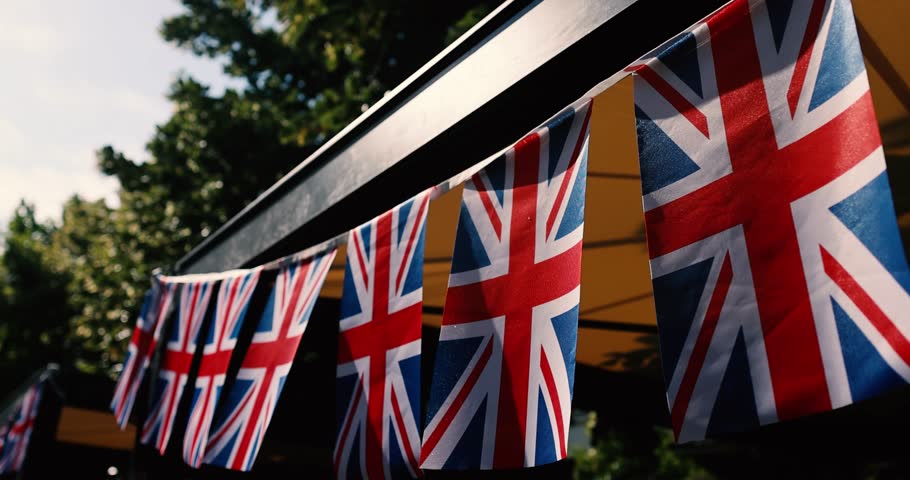 Details with the United Kingdom flags waving in the wind during a UK national celebration.
