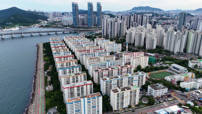 Amazing aerial view of the cityscape in busan, south korea. A densely populated coastal city with modern high rise buildings and apartments