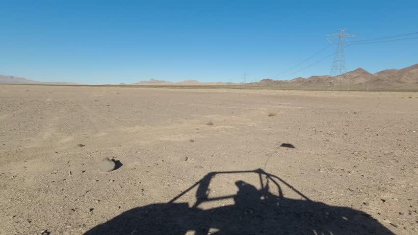 Driving through the desert in Las Vegas with the shadow of the vehicle
