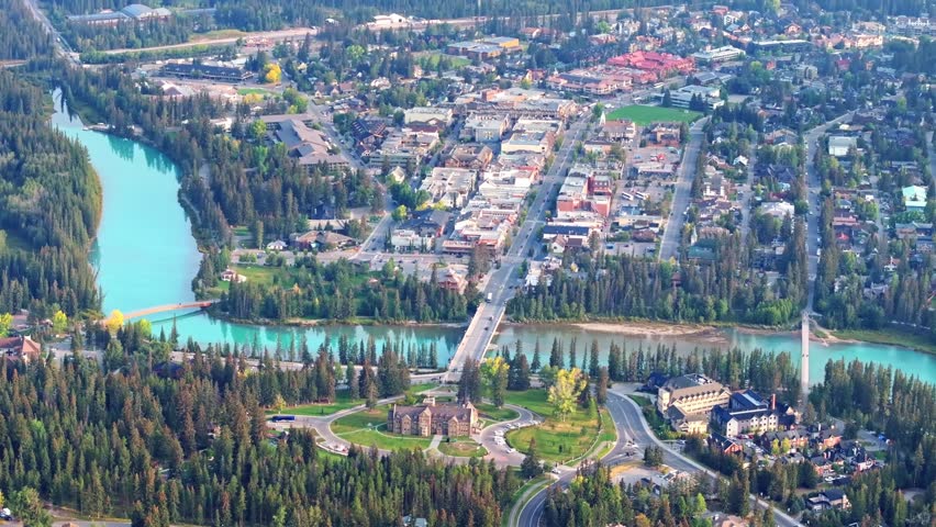 Capturing Banff Avenue, Bow river with turquoise water, picturesque townscape surrounded by forested valleys and mountain ranges in Alberta, Canada.