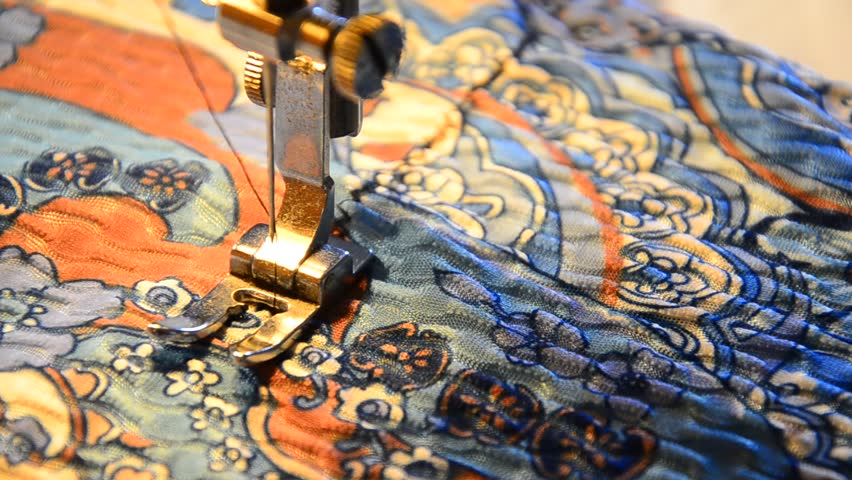 sewing machine working part with colorful cloth. Needle stitch zigzag on