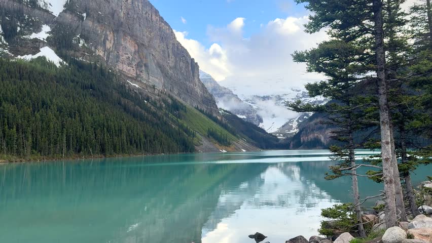 Beautiful lake and mountains in Banff National Park with blue water and trees in summer