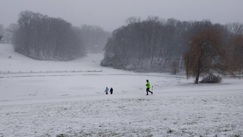 Athletic sportive jogger runs through the Woluwe park in Woluwe-Saint-Pierre - Brussels, Belgium