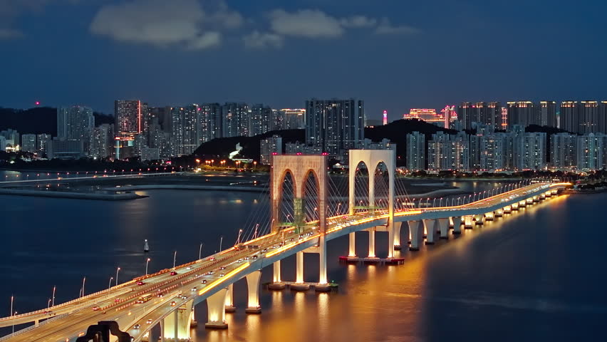 Night view of the illuminated Sai Van Bridge and Macau city skyline across the sea, Macau, China