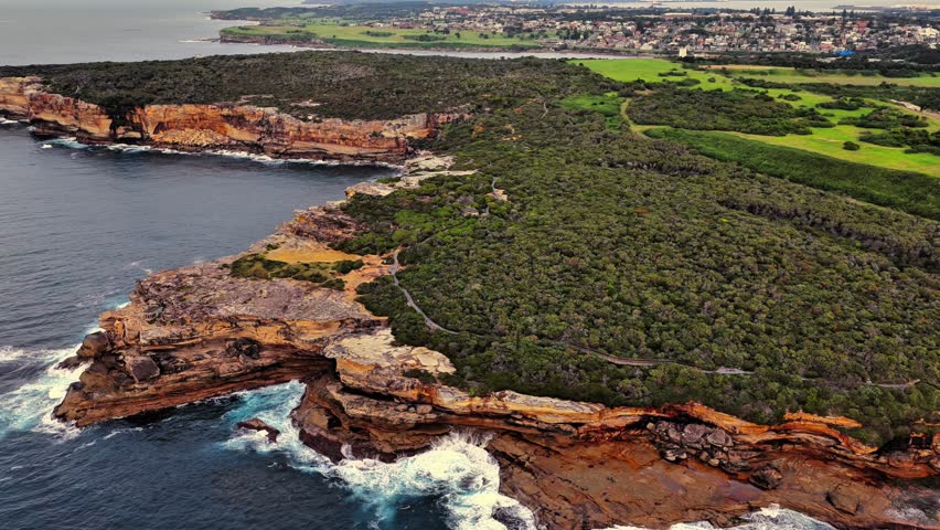 Aerial view of the rugged sandstone cliffs and coastal vegetation of Maroubra headland overlooking the Pacific Ocean in Sydney, New South Wales, Australia.