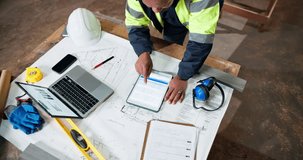 Top view, tablet screen and engineer at construction site for building development, project or chart. Above, tech and black man with architecture blueprint, floor plan and scroll analytics report - Powered by Shutterstock - Get 15% off with code: PIKWIZARD15