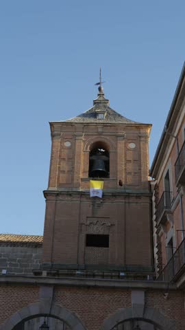 Close Up View of Historic Brick Church Bell Tower With Large Bronze Bells