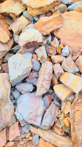 Natural background of colorful raw stones and cracked rock texture for wallpaper and graphic design template
