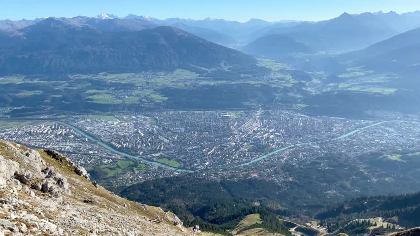 High angle aerial view of Innsbruck city and the winding Inn River from the Nordkette range