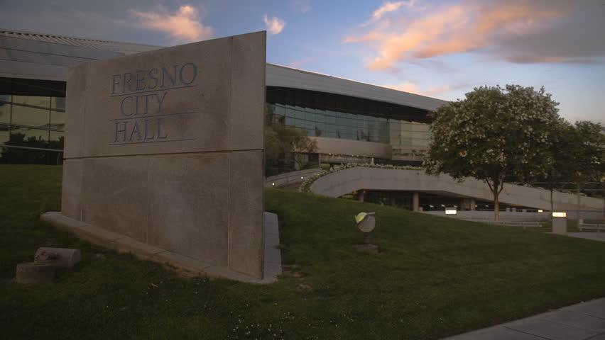 Fresno, California - June, 2013 - Medium shot of Fresno City Hall building in the background and stone signage in the foreground. Shot as raw from Canon 5D Mark II with Magic Lantern.