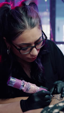Artist, woman and tattoo on leg in shop, aesthetic and creative ink design with equipment or skills. Needle, sketch and person with tool for self expression, outline and client with body art in store