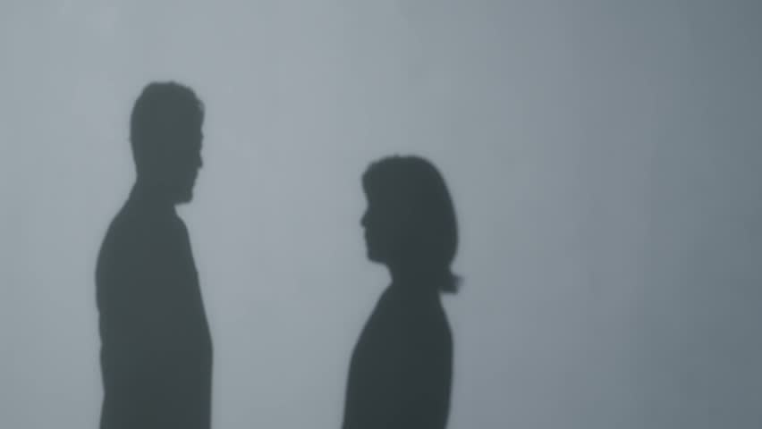 Silhouettes of a man and a woman arguing. Couple, married couple, quarrel, conflict, hostility, colleagues, work, dissatisfaction, dispute, reprimand, argument.