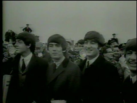 British rock'n'roll band the Beatles poses in Heathrow Airport, London circa 1964-MGM PICTURES, UNIVERSAL-INTERNATIONAL NEWSREEL, USA, filmed in 1964 