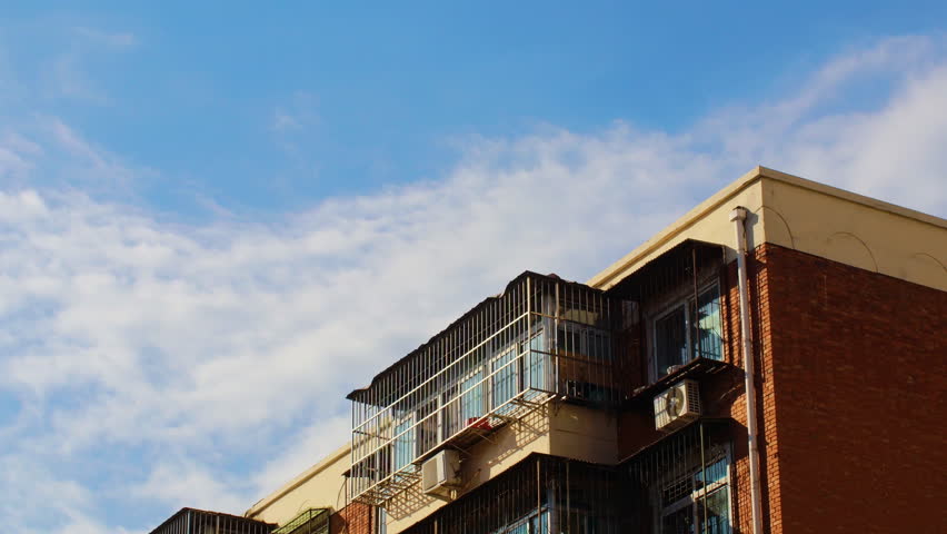 Blue Sky And White Clouds Passing Over Rooftops
